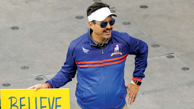 A fan dressed up as Ted Lasso stands with a believe sign before a MLS game between the Philadelphia Union and Toronto FC at BMO Field.